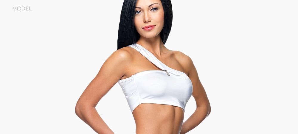 Female Fitness Model With White Sports Bra and Black Hair