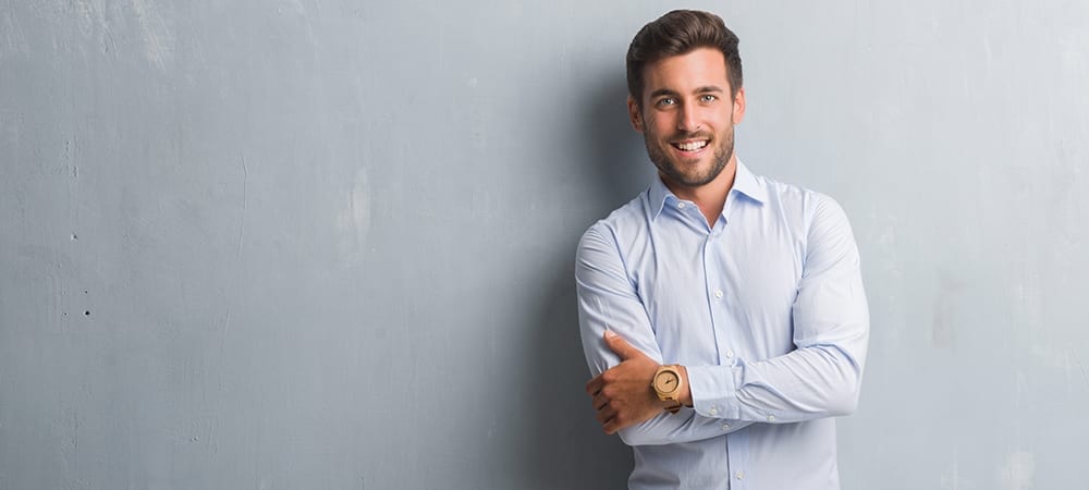 Smiling Male Professional With Blue Collar Shirt and Light Wooden Watch