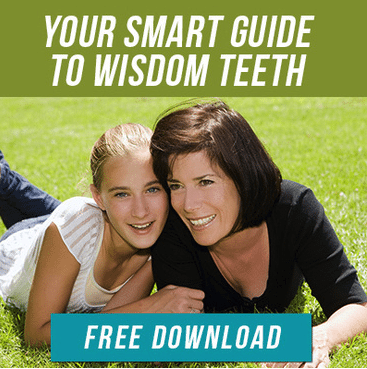 mother and daughter laying on grass together_your smart guide to wisdom teeth