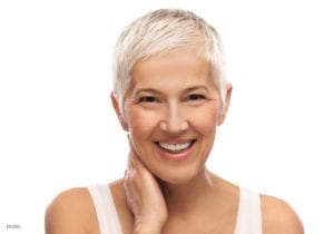 Mature Female with short white hair and white top smiling