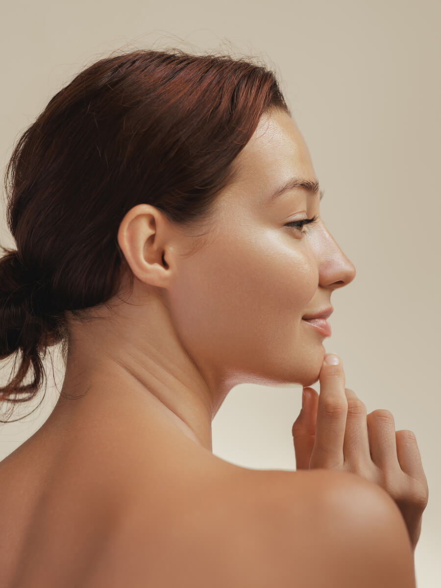 Profile of a young woman touching her chin