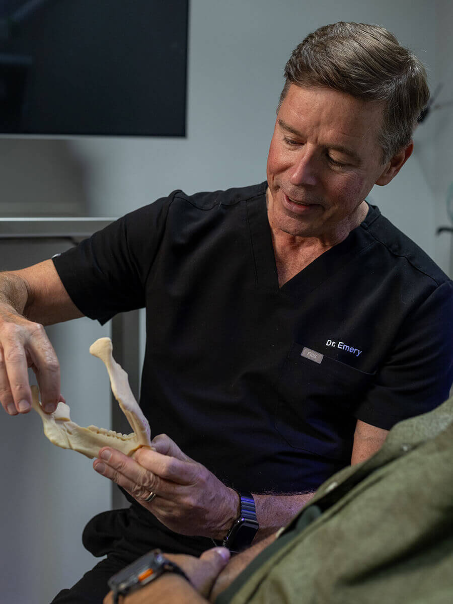 Dr. Emery holding a lower jaw replica