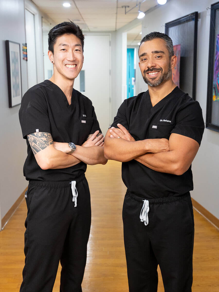 Dr. Retena and Dr. Shim in scrubs