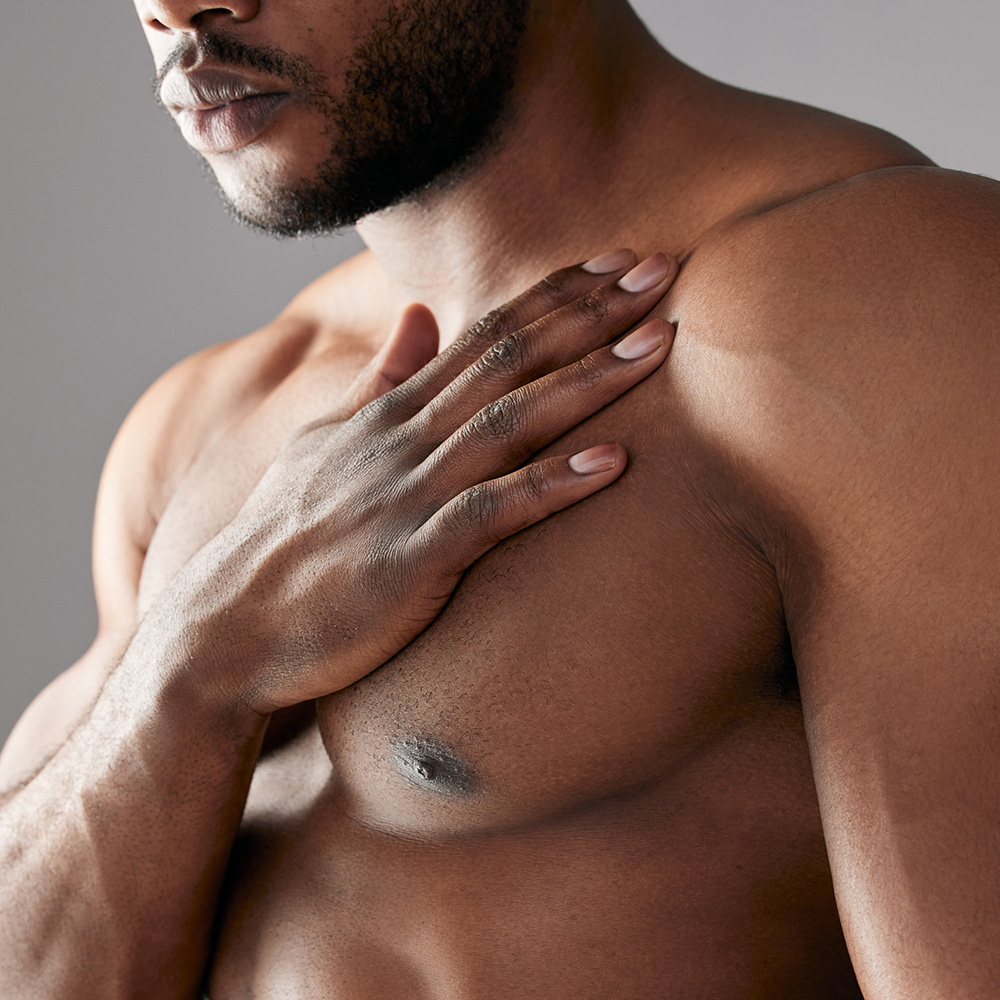 Fit man with his hand on his chest